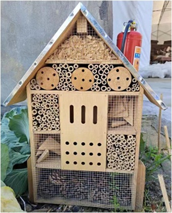 giant insect hotel with metal roof  and stakes